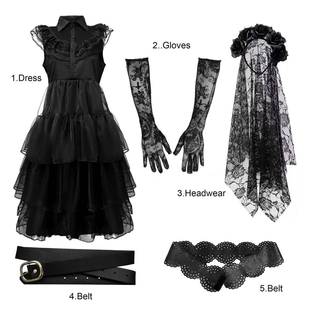 Gothic black tiered dress set flat lay showing dress, lace gloves, veil headpiece and belts